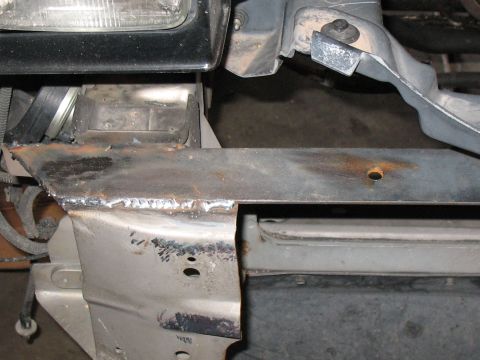 2001 Pontiac Trans Am - Close-up of welded metal frame sections, indicating repair work on a vehicle's front end.
