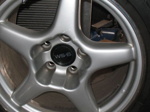 2001 Pontiac Trans Am - A close-up of a wheel a WS-6 center cap, with a radiator visible in the background.