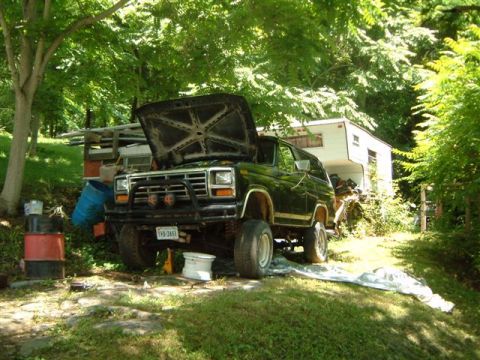 1982 Ford Bronco - 1982 Ford Bronco with hood open, parked outdoors near a trailer.