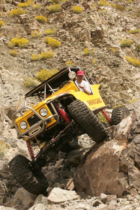 1991 Ford Bronco - This custom buggy navigates a steep, rocky incline in a desert environment.