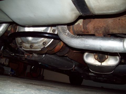1999 Mercury Grand Marquis - Underbody shot looking up at the rear of a car showing the differential housing cover, a black-painted rear sway bar running across the cha…