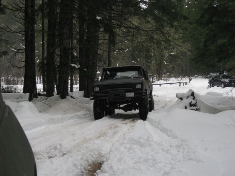 1979 Ford Bronco driving through snow with lifted suspension