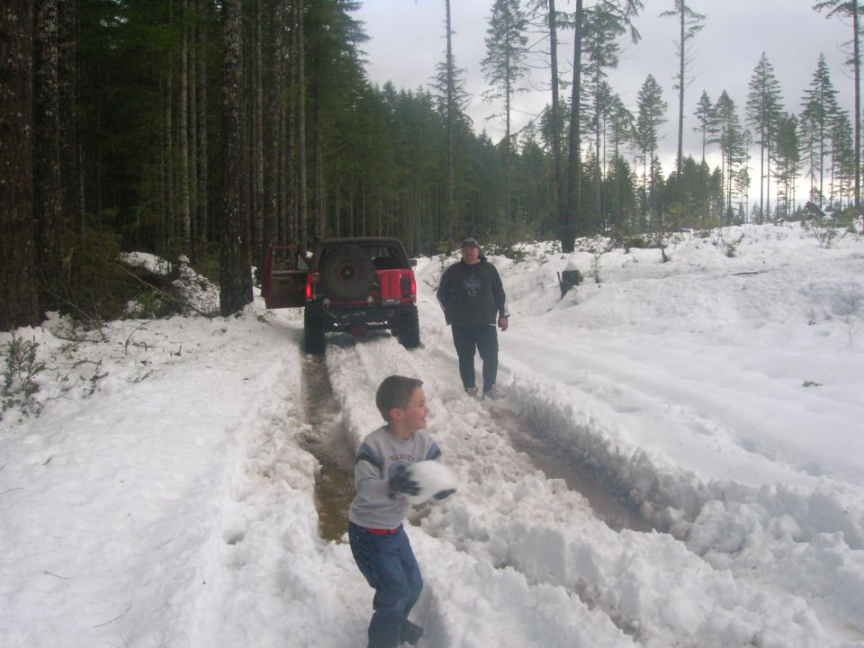 Red 1996 Ford Bronco rear view in snowy forest