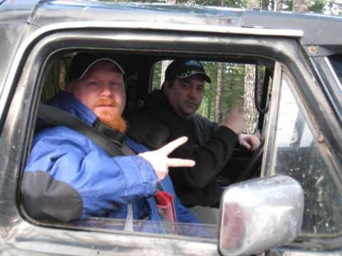 1989 Ford Bronco - Two men pose for a photo inside a vehicle, with trees visible in the background.