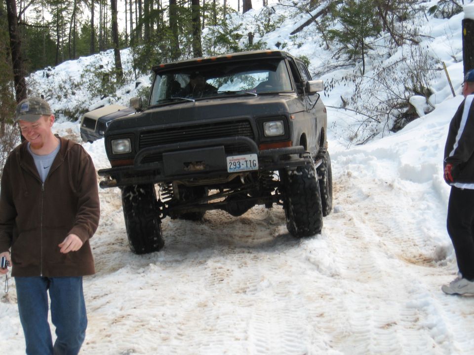 Black lifted Ford Bronco with a winch and license plate 293-TIG in the snow