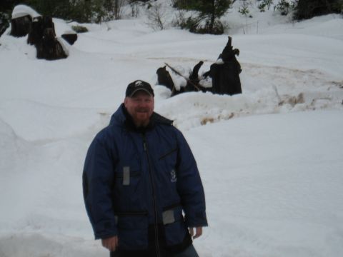 1989 Ford Bronco - A man poses for a photo in a snow-covered outdoor area with several large tree stumps visible in the background.