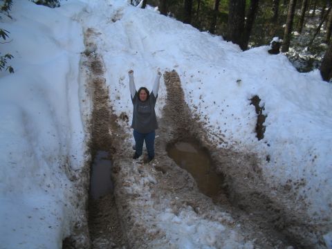 1989 Ford Bronco - A person celebrates in a challenging snowy and muddy off-road track.