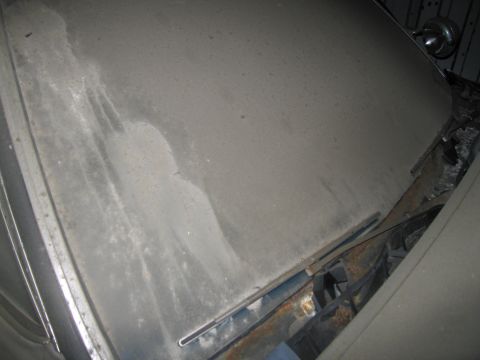 1991 Ford LTD Crown Victoria - A dusty car hood shows water stains and rust around the windshield wiper area.