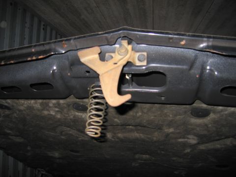 1991 Ford LTD Crown Victoria - The hood latch mechanism and spring are visible in this close-up view.