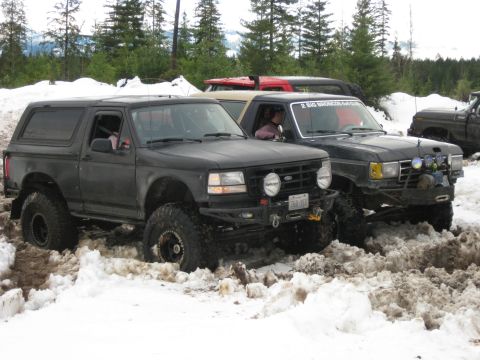 1979 Ford Bronco - Multiple off-road vehicles navigate a snowy terrain during an event.