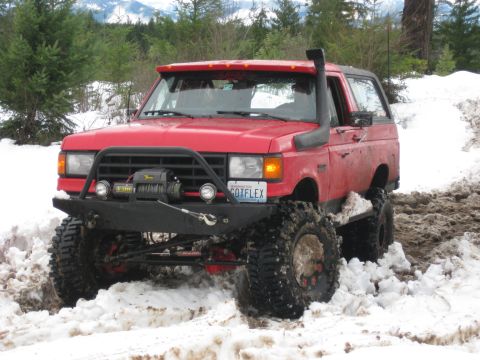 1979 Ford Bronco - This modified SUV navigates a snowy trail with its snorkel and winch ready for action.