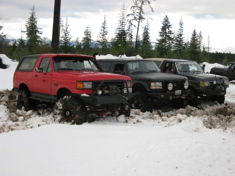 1979 Ford Bronco - Several off-road vehicles are stuck in the snow during a winter outing.