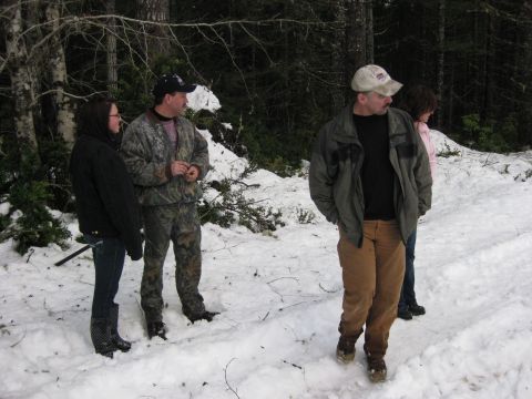 1979 Ford Bronco - A group of people are gathered in a wooded area covered in snow.