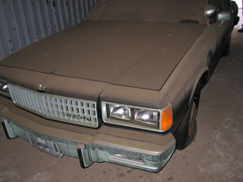 1991 Ford LTD Crown Victoria - Front view of a dusty Chevrolet Caprice, showing the grille and headlights.