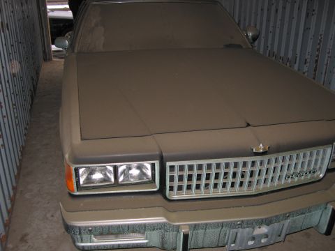 1991 Ford LTD Crown Victoria - This dusty Chevrolet Caprice has a prominent chrome grille and square headlights.