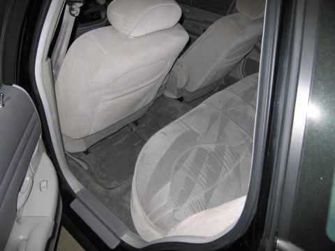 1991 Ford LTD Crown Victoria - Rear interior view of a 1991 Ford Crown Victoria LTD, showing the cloth seats and door panel.