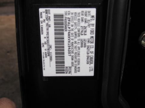 1991 Ford LTD Crown Victoria - Ford certification label showing VIN 2FALP74WXVX154357, manufacture date, and weight rating data.