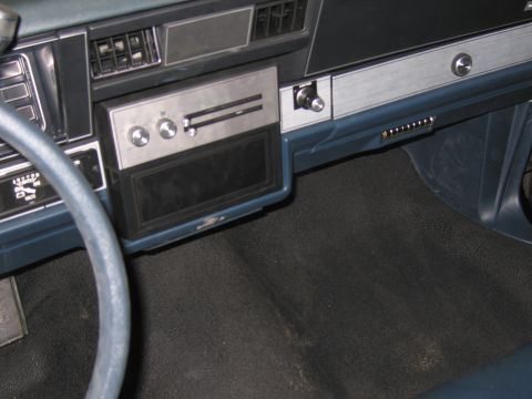 1991 Ford LTD Crown Victoria - Close-up of a car's dashboard, showing the radio and part of the steering wheel.