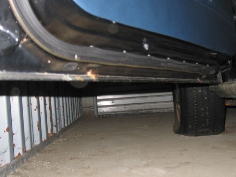 1991 Ford LTD Crown Victoria - Door sill and flat tire of a car, showing signs of wear and tear.