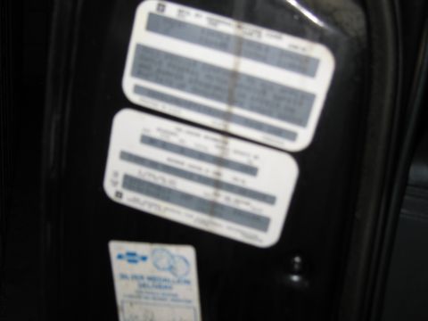 1991 Ford LTD Crown Victoria - Stacked GM door-jamb identification and certification data plates with specifications text.