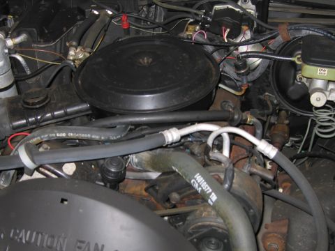1991 Ford LTD Crown Victoria - Close-up view of an engine bay, showing various components and hoses.