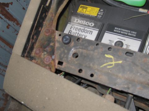 1991 Ford LTD Crown Victoria - A Delco Freedom Battery is visible within a vehicle's interior, showing signs of rust on surrounding metal components.