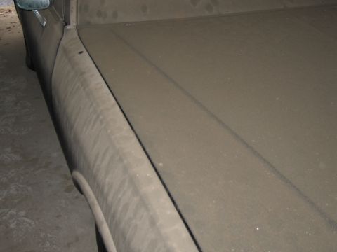 1991 Ford LTD Crown Victoria - A car covered in dust sits in what appears to be a garage.