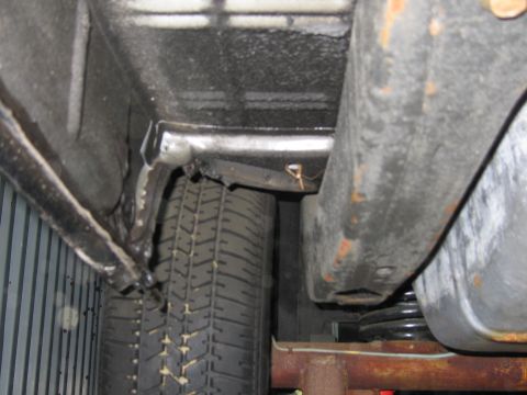 1991 Ford LTD Crown Victoria - Close-up view of the undercarriage, showing suspension components and a tire.