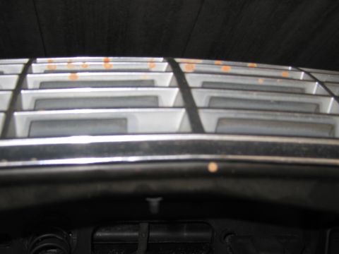 1991 Ford LTD Crown Victoria - Photograph of a vehicle's chrome grille and cowl trim with surface rust spots.
