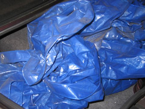 1991 Ford LTD Crown Victoria - Photograph of a blue tarp in a trunk, not a technical document.