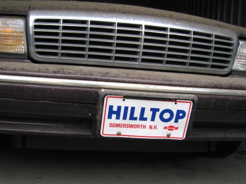 1991 Ford LTD Crown Victoria - Photograph of a Chevrolet front grille and dealer plate, not a technical document.