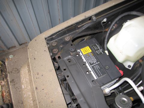 1991 Ford LTD Crown Victoria - Photograph of a vehicle battery mounted in the engine bay, not a technical document.