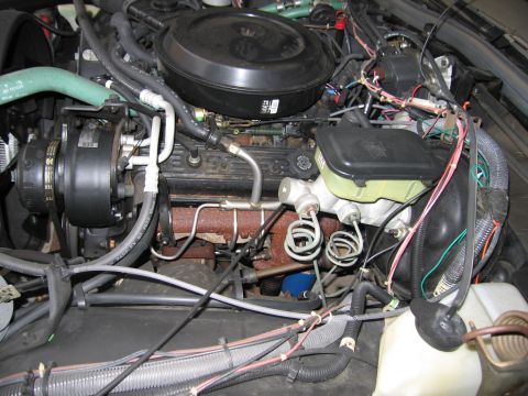 1991 Ford LTD Crown Victoria - Photograph of an engine compartment with brake master cylinder and hoses, not a technical document.