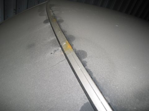 1991 Ford LTD Crown Victoria - Photograph of exterior trim molding on a vehicle body panel, not a technical document.