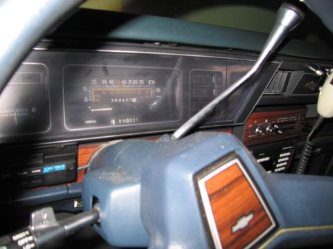 1991 Ford LTD Crown Victoria - Photograph of a dashboard instrument cluster and center stack, not a technical document.