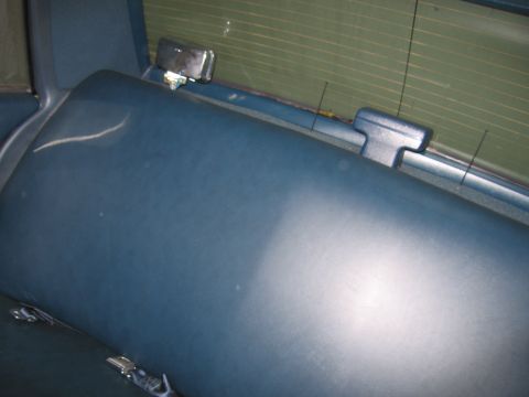 1991 Ford LTD Crown Victoria - Photograph of a car interior rear deck and seat, not a technical document.