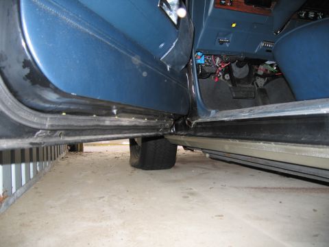 1991 Ford LTD Crown Victoria - Photograph of a vehicle door sill and rocker panel, not a technical document.