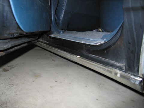 1991 Ford LTD Crown Victoria - Photograph of a vehicle door sill and rocker panel, not a technical document.