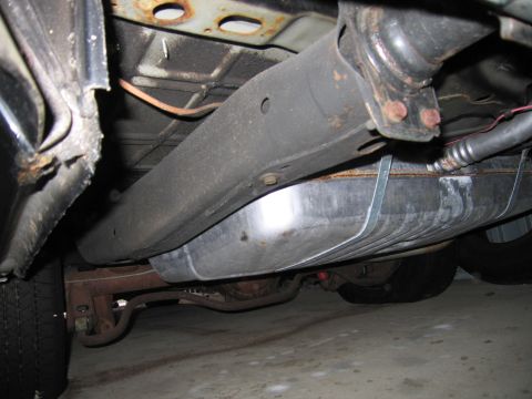 1991 Ford LTD Crown Victoria - Photograph of a vehicle undercarriage with fuel tank and exhaust, not a technical document.