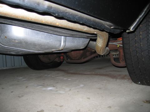 1991 Ford LTD Crown Victoria - Photograph of a vehicle undercarriage and exhaust, not a technical document.