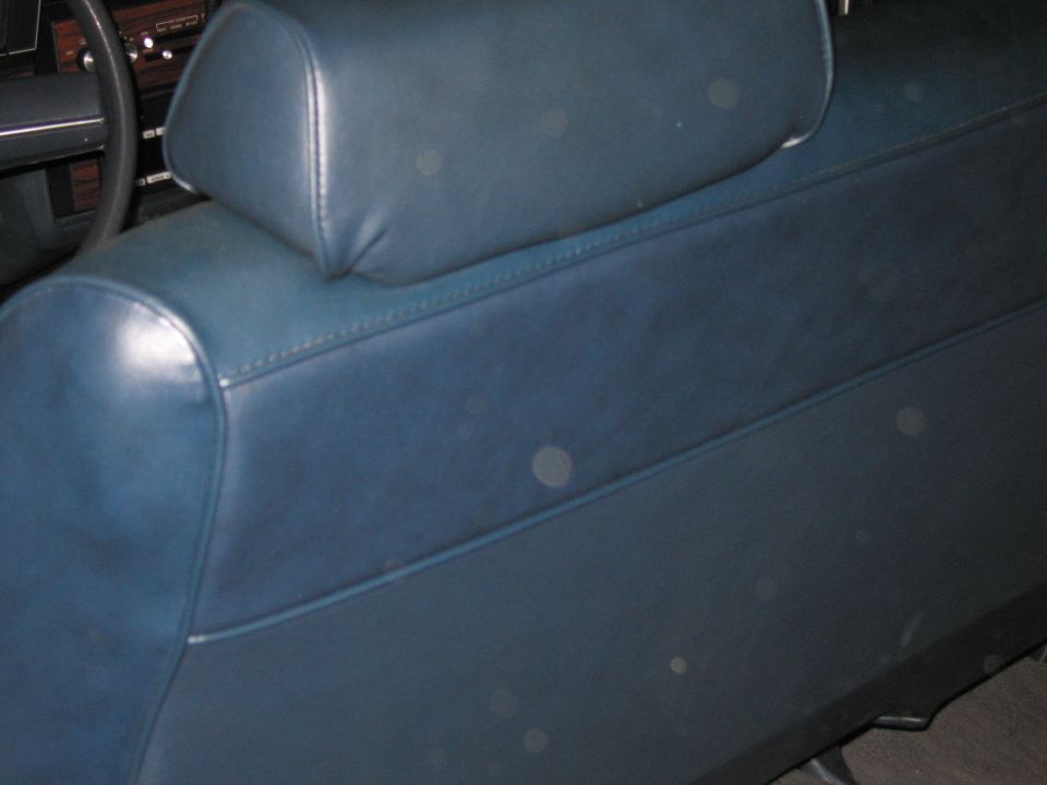 Photo of a blue vinyl car seat back and headrest