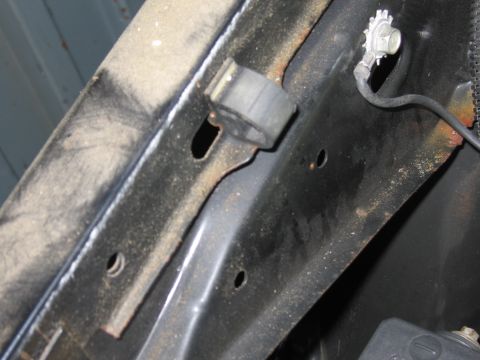 1991 Ford LTD Crown Victoria - Photograph of vehicle sheet-metal and a bracket, not a technical document.