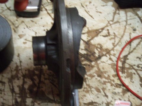 1996 Ford Bronco - A close-up, angled view of a dark metal automotive differential housing. A red wire or hose is visible to the right of the part.