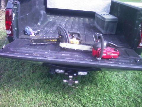 2001 Ford F-150 - Chainsaws are loaded in the bed of a pickup truck with the tailgate down.