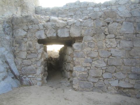 1968 Ford Mustang - Ancient stone structure with a narrow passage, suggesting a historical site.