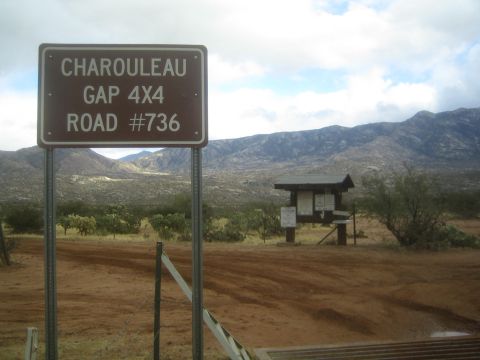 1968 Ford Mustang - A sign marks Charouleau Gap 4x4 Road #736 in a dry, mountainous region.