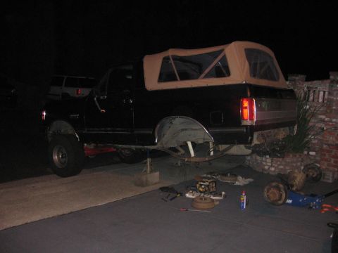 1989 Ford Bronco - Rear axle removed from a 1989 Ford Bronco for rebuild, with parts laid out.