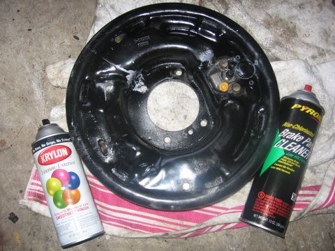 1989 Ford Bronco - A brake drum assembly sits on a cloth next to cans of Krylon and Pyrol brake cleaner.