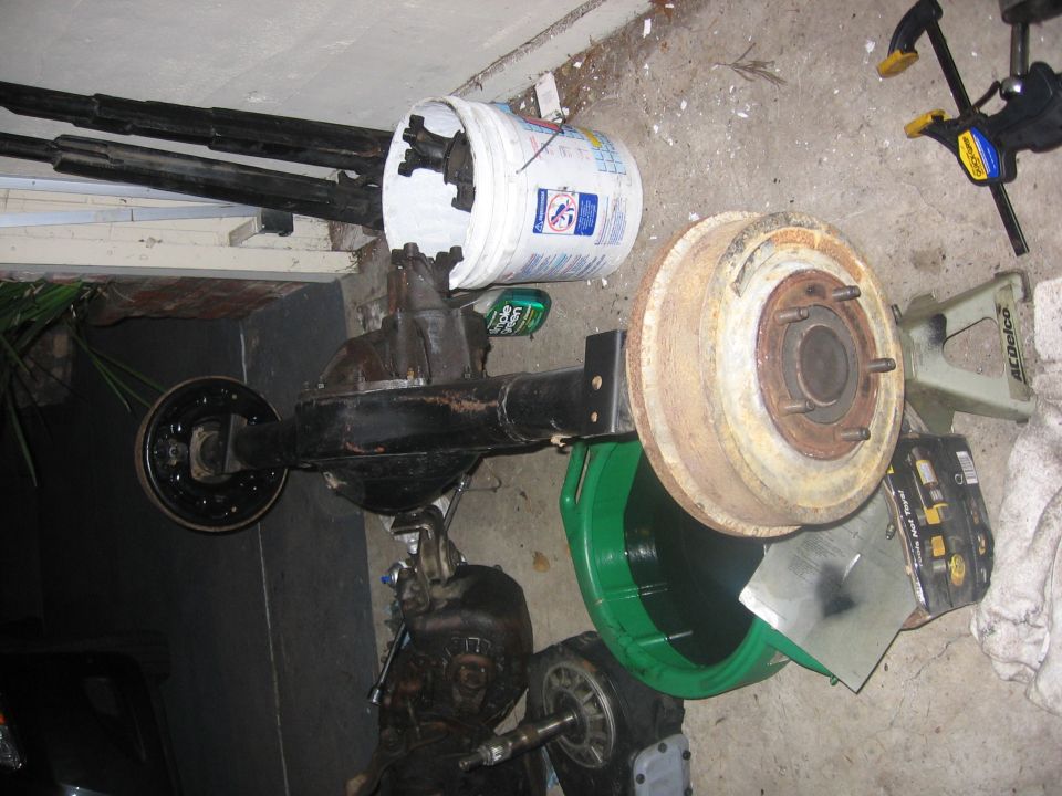 Rear axle assembly with brake drum and bucket of parts