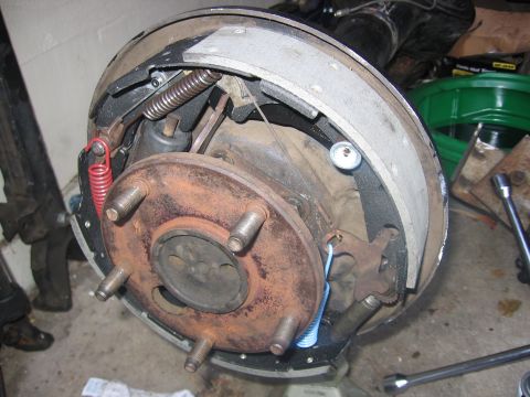 1989 Ford Bronco - This image shows a close-up view of a vehicle's brake drum assembly, highlighting the brake shoes and springs.